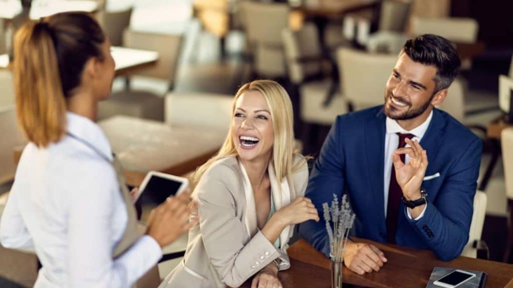 Man and a woman smiling while ordering food in the restaurant