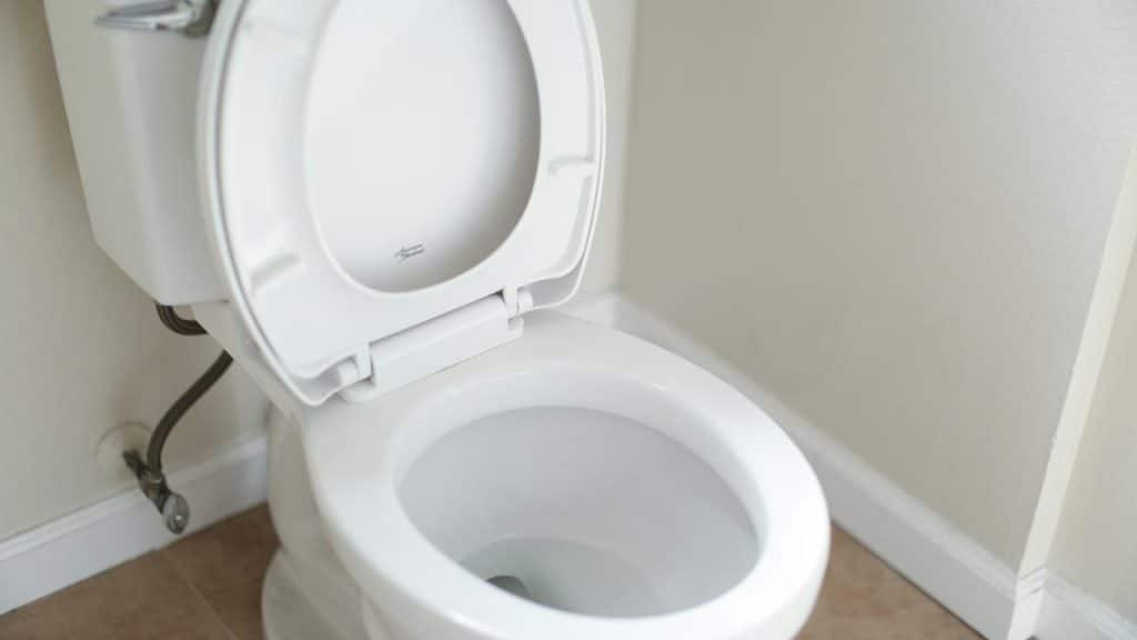 A white toilet with the seat lid open.