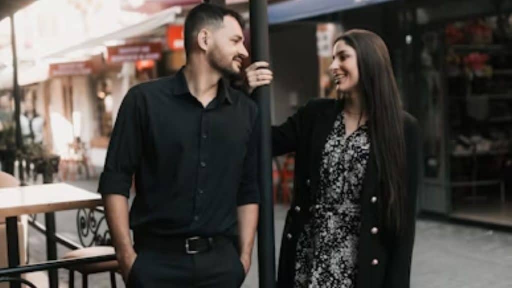 Couple smiling as they say goodbye outside a restaurant