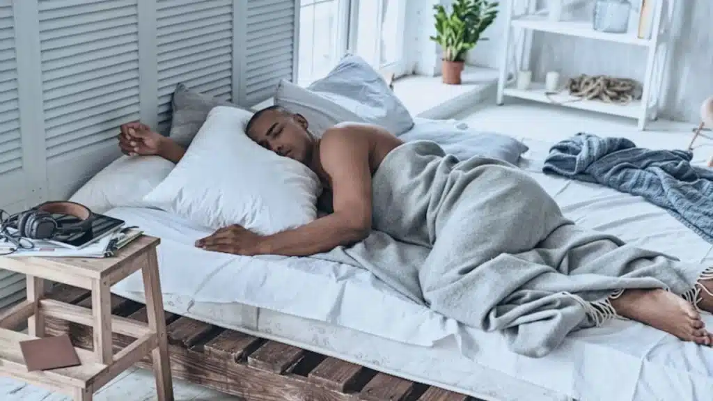 A man lying in bed sleeping soundly
