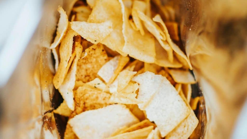An open bag filled with potato chips.