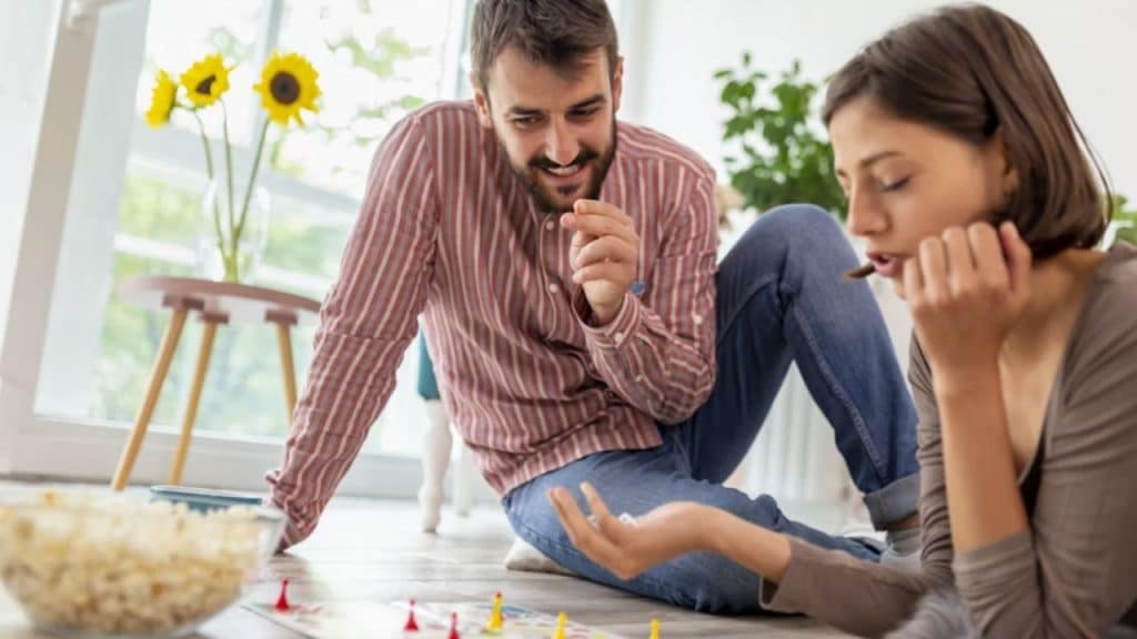 Couple playing a board game at home