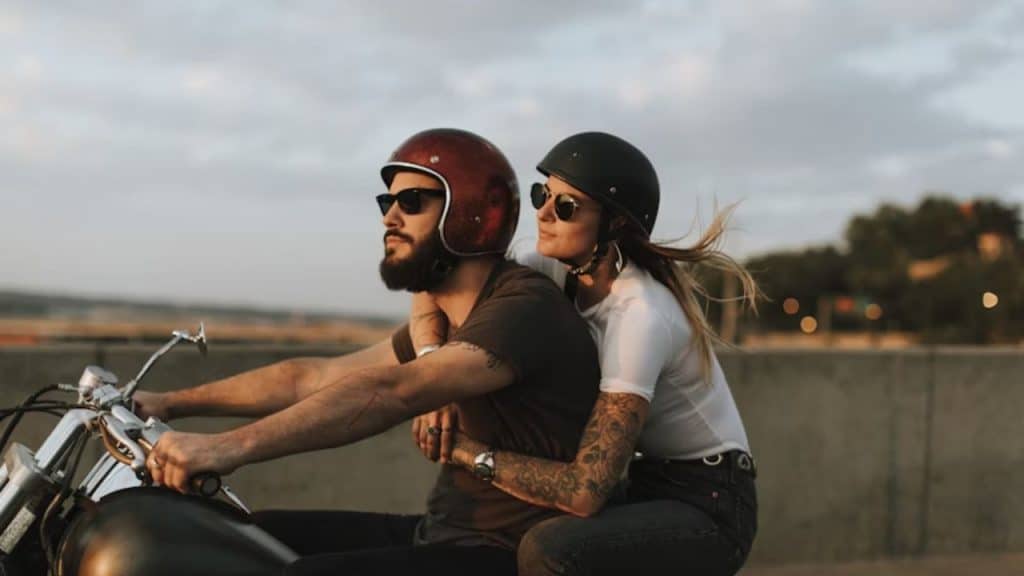 Couple riding a motorbike for surprise outing
