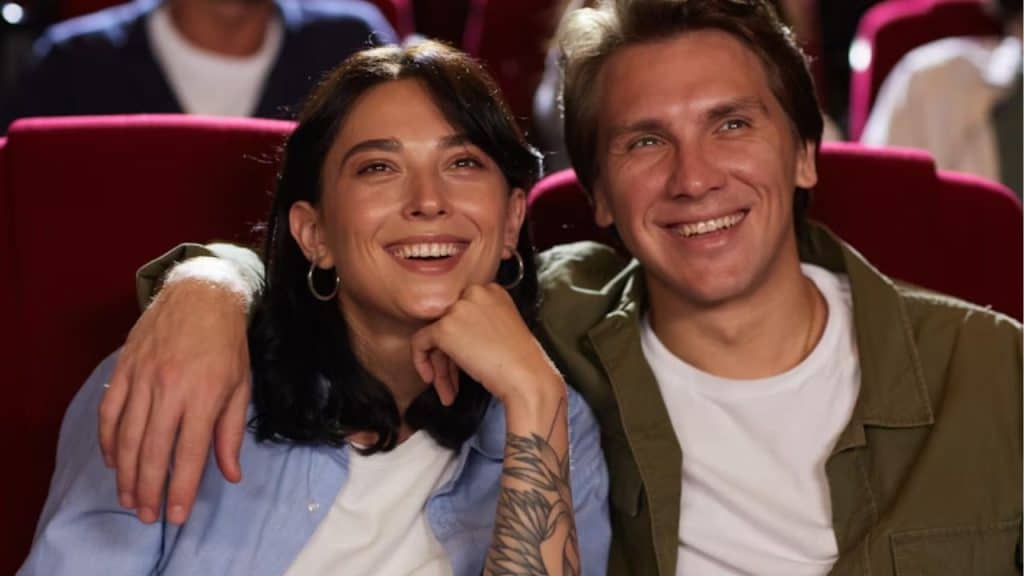 Couple smiling together in the audience at a comedy club