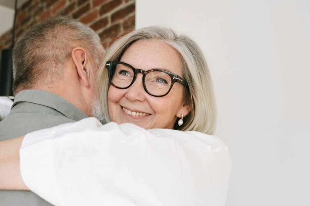 A man and woman hugging each other