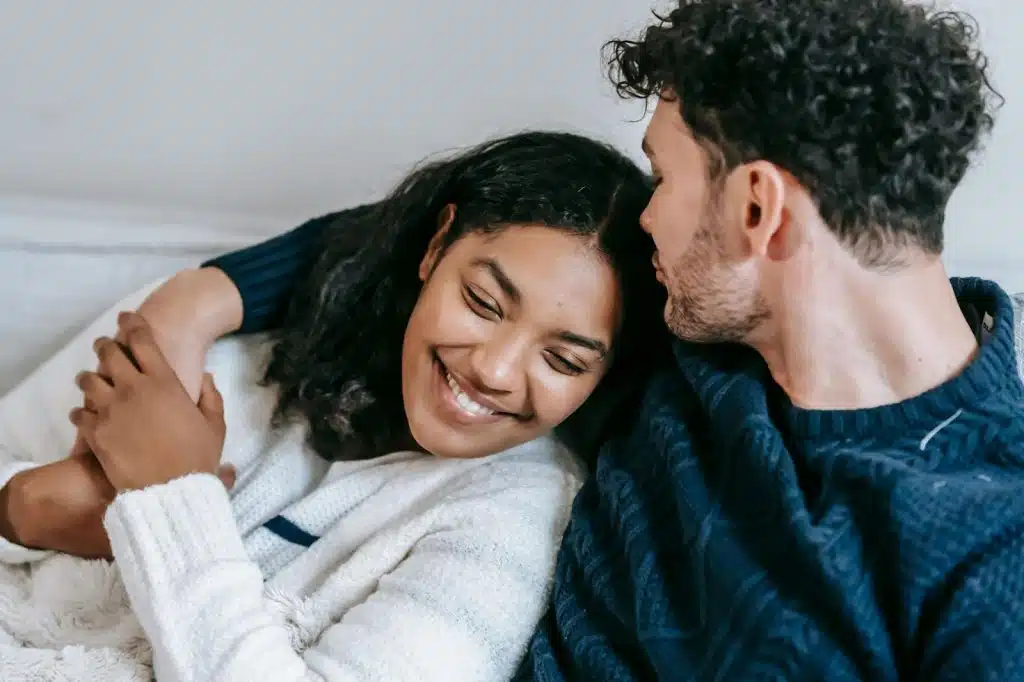 A man kissing a woman’s forehead