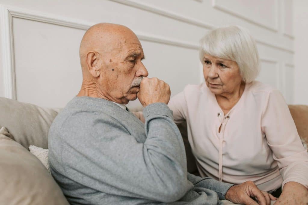 A woman taking care of a sick man