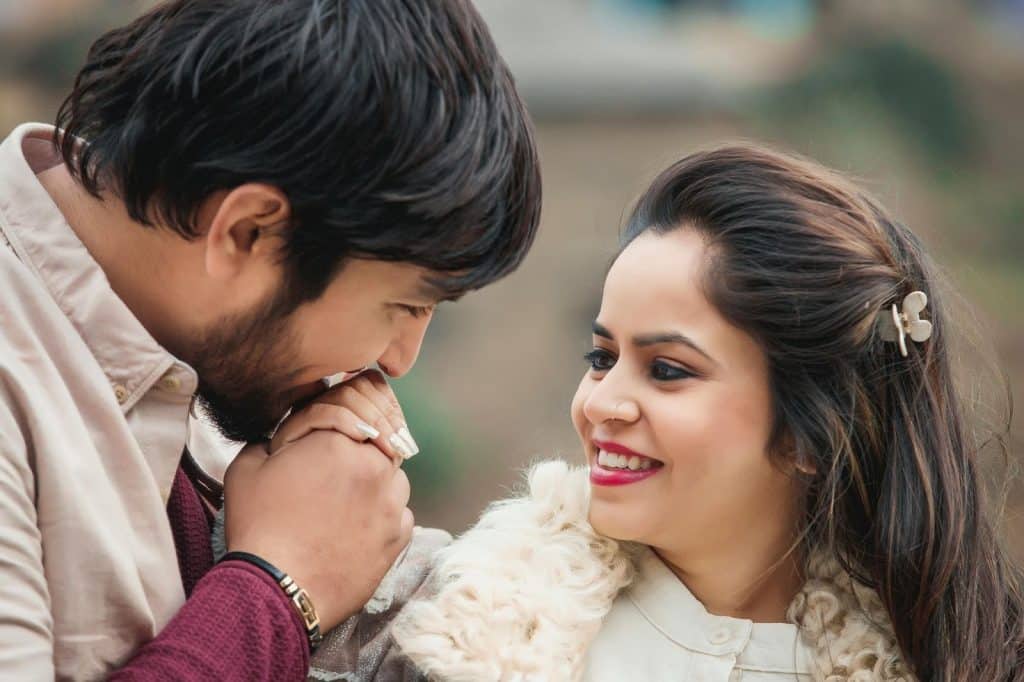 A man kissing a woman’s hand