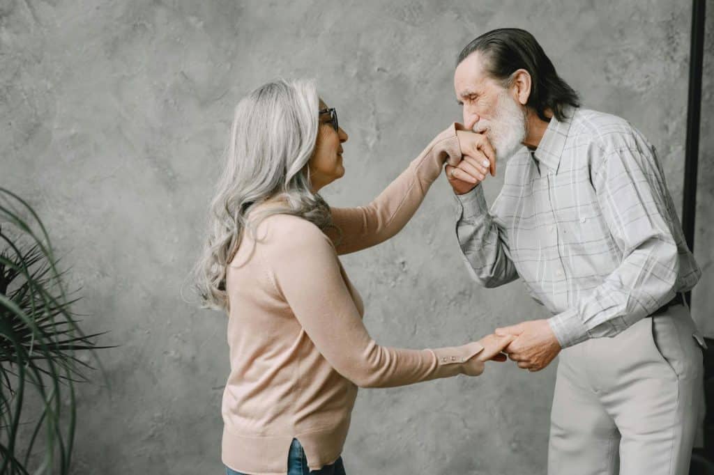 A man kissing a woman’s hand 