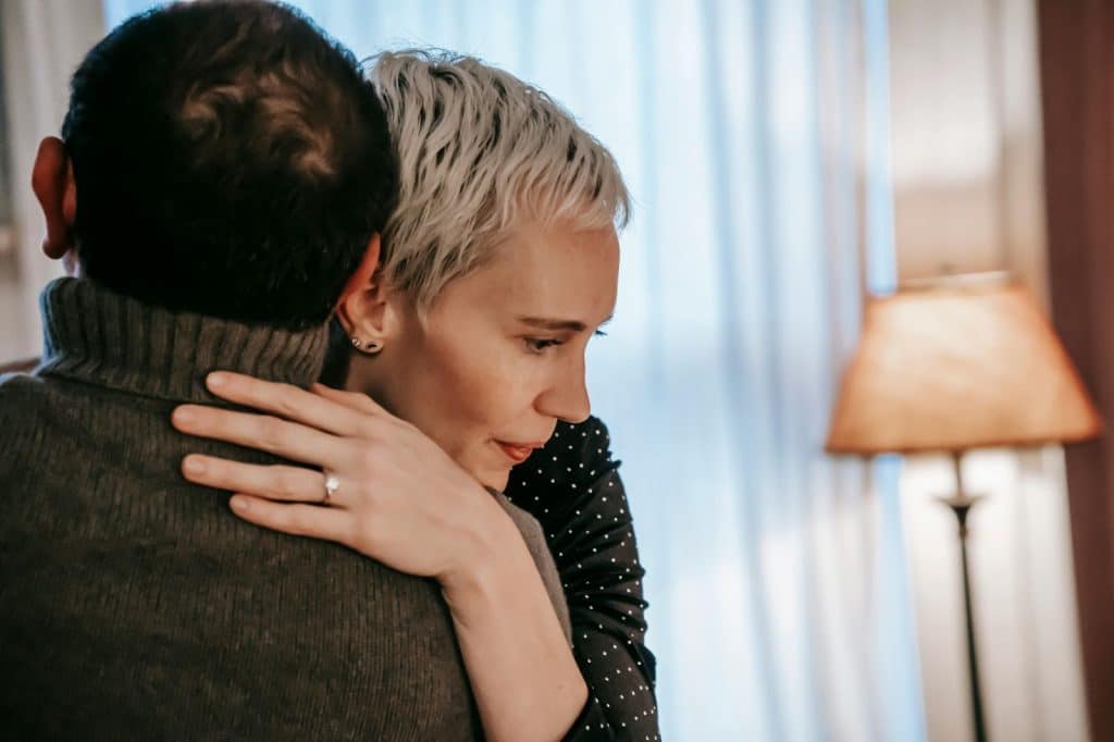 A man hugging a woman