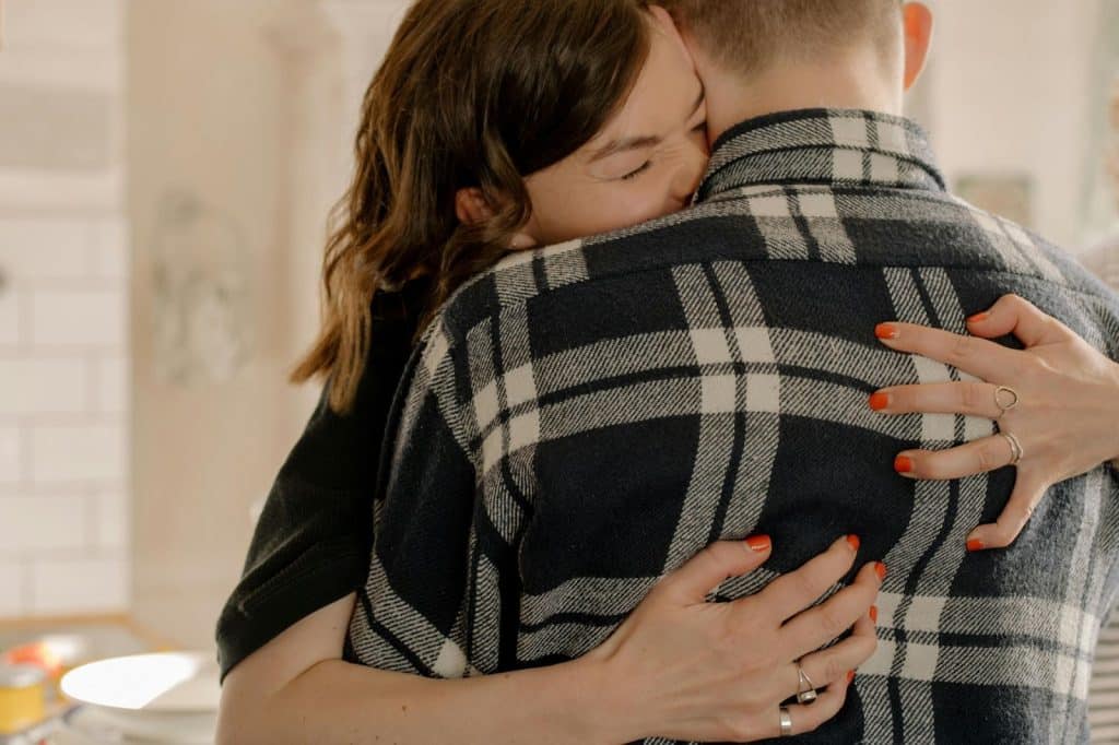A woman hugging a man