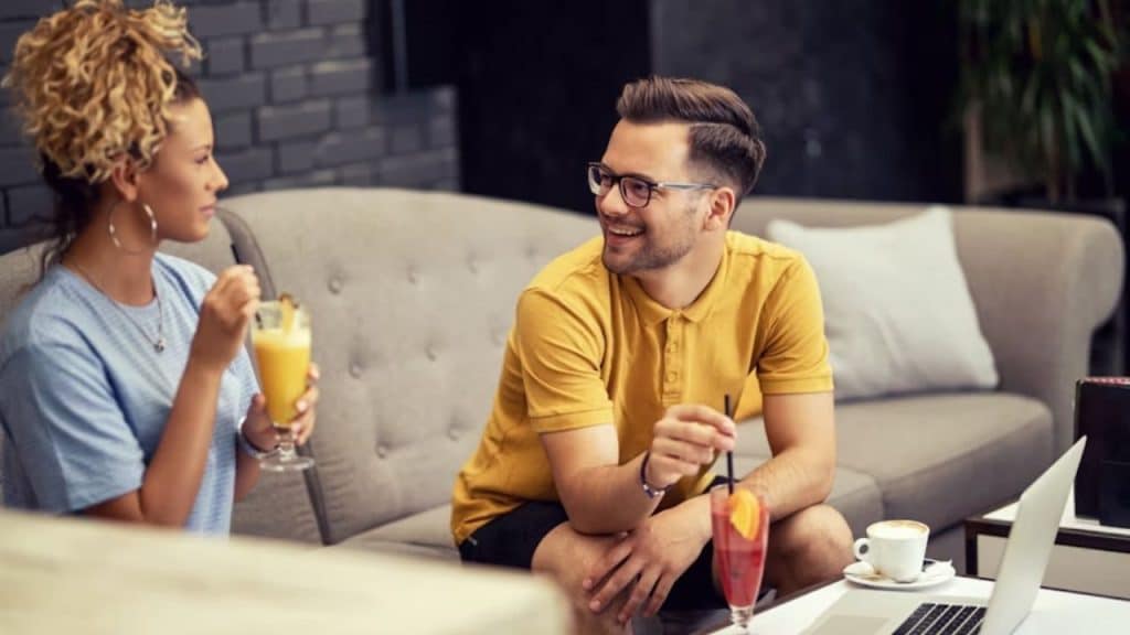 Couple smiling and talking at a table