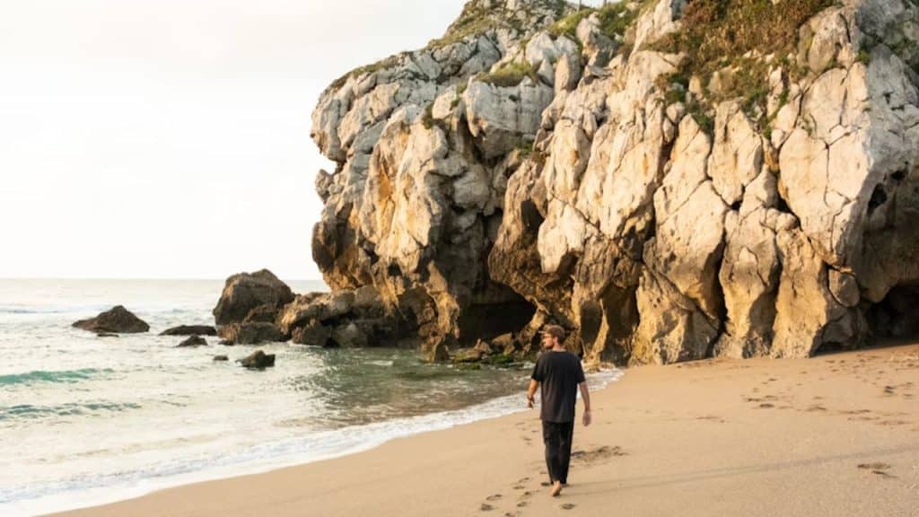 Man walking confidently alone at sunset