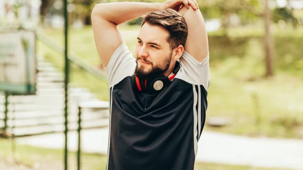 Man stretching confidently after workout