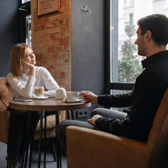 A woman looking at the man