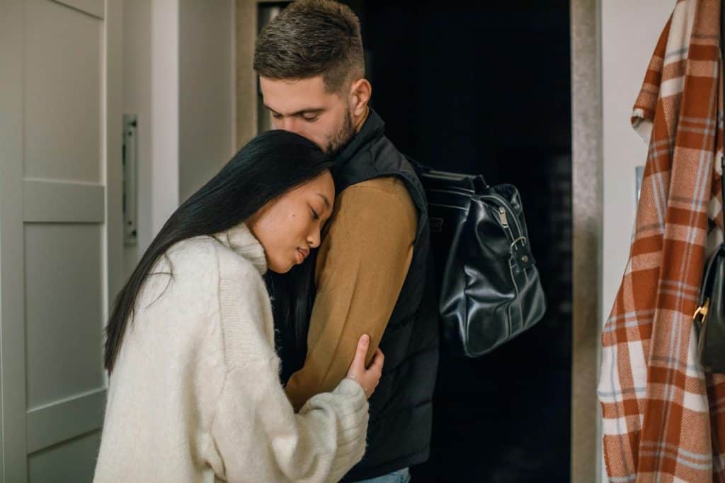 A man  kissing a woman’s head