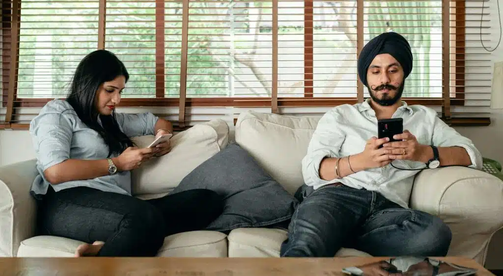 A man and woman using devices
