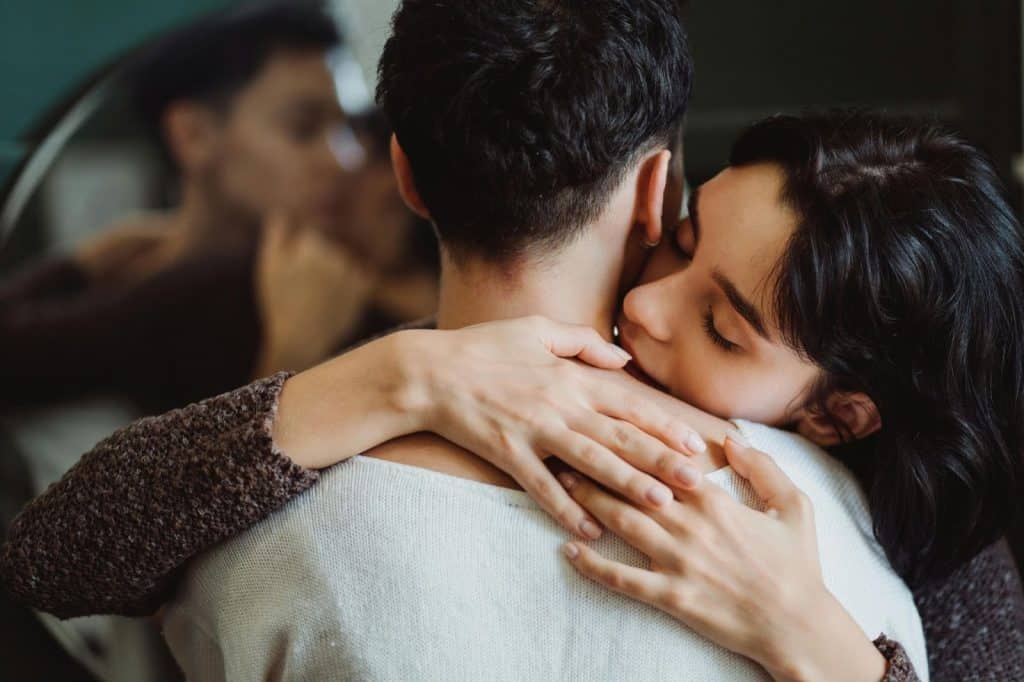 A woman hugging a man