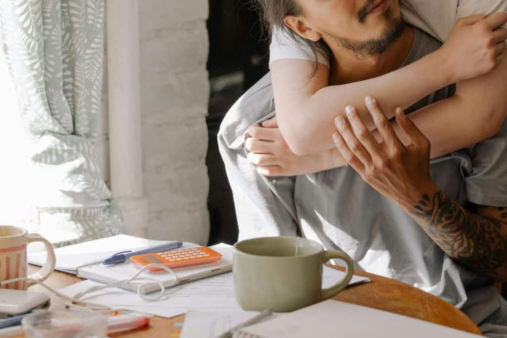 A woman hugging a man 