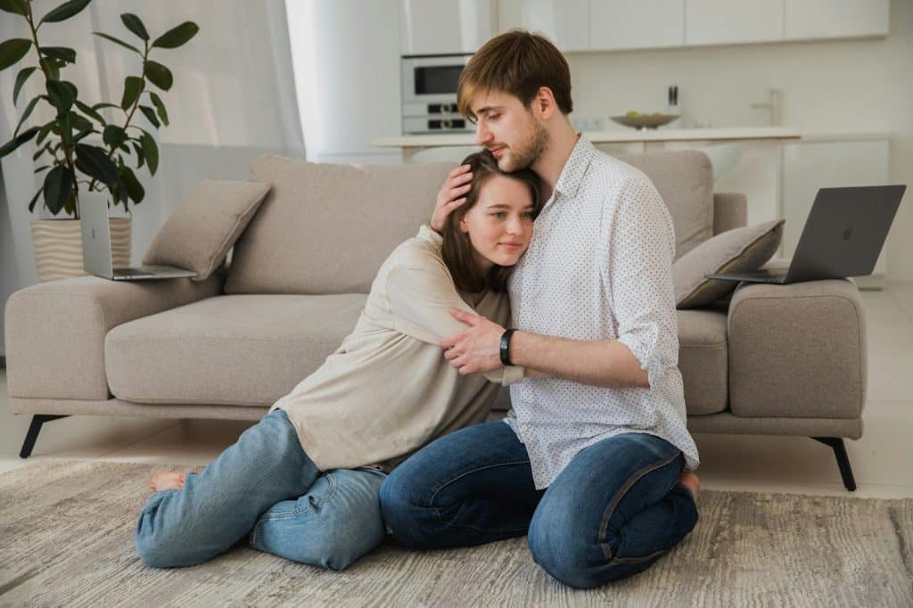 Couple hugging at the living room