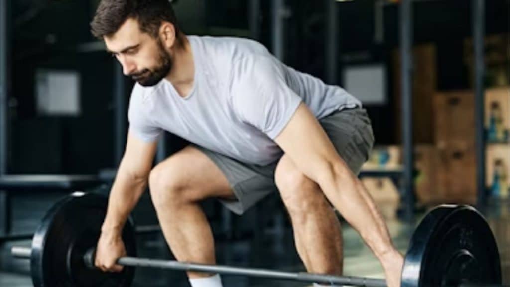A man lifting weights in a gym with determination