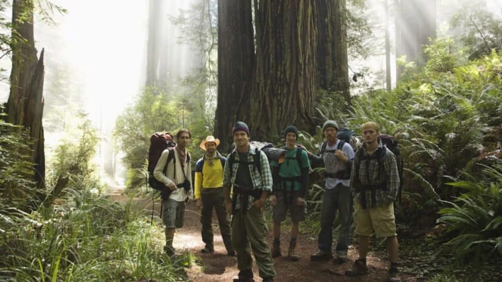 Men standing on a trail in the woods