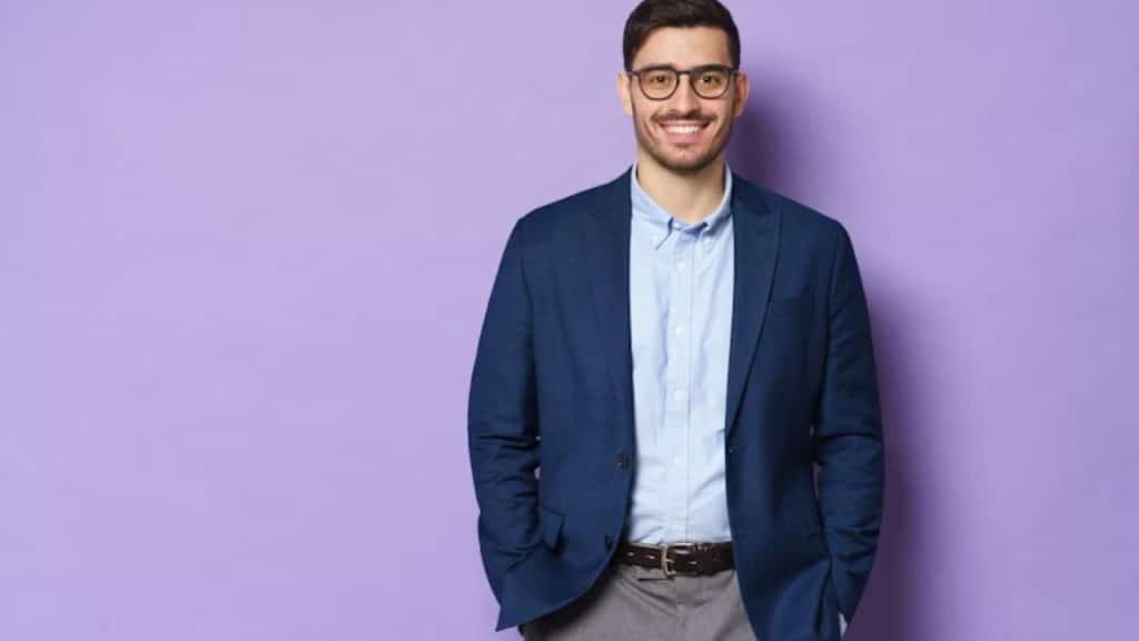A man standing confidently in business casual clothing