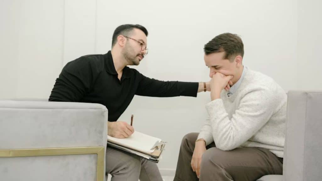 A man talking with a therapist in an office setting