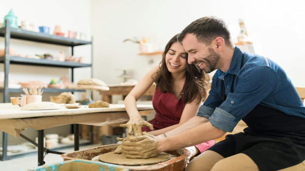 A couple doing pottery together 