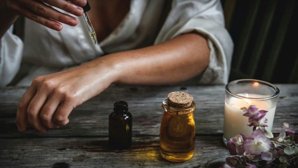 A woman pouring essential oils