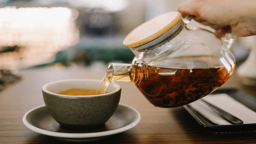 A person pouring tea