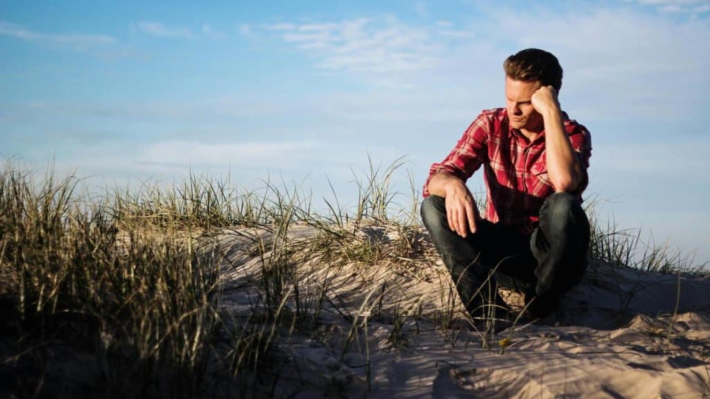 A man thinking while on the beach 