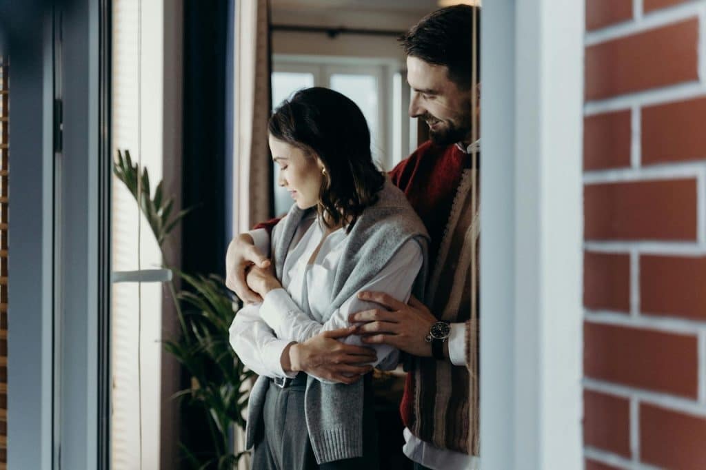 A man holding a woman from behind