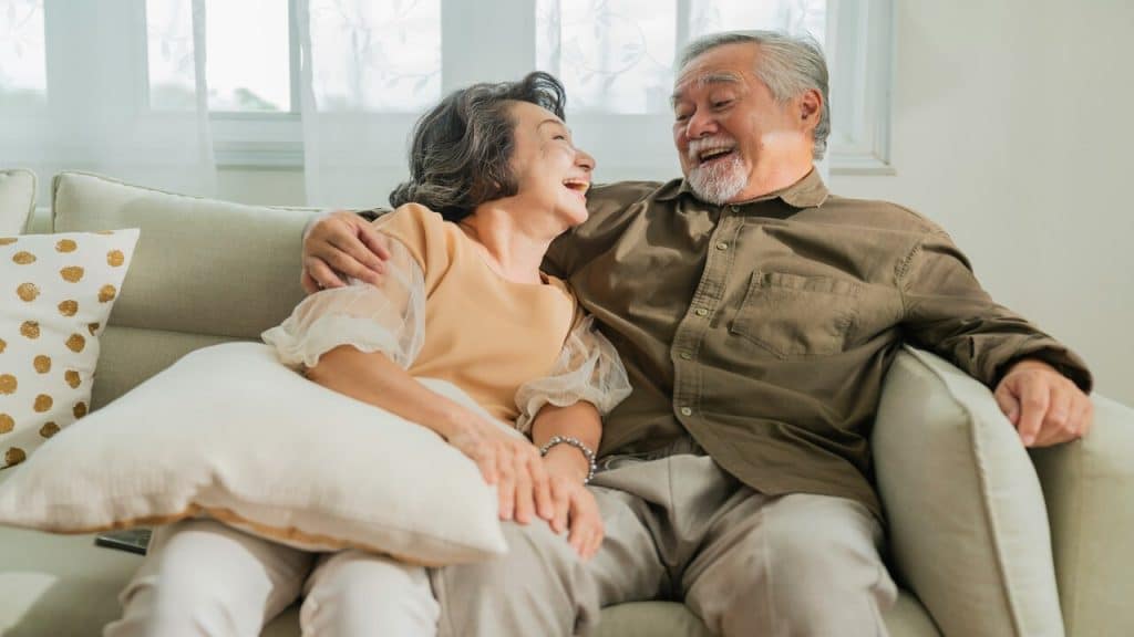 A couple talking and laughing at home