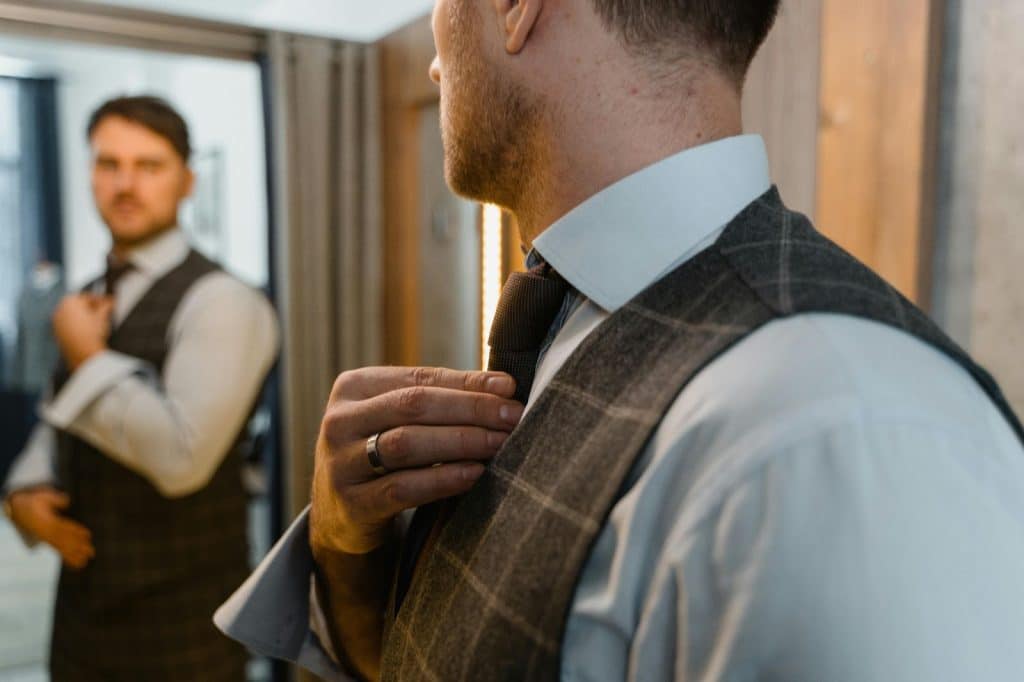 A man fixing his tie