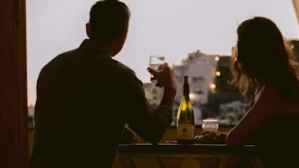 A couple sitting at the dinner table barely talking