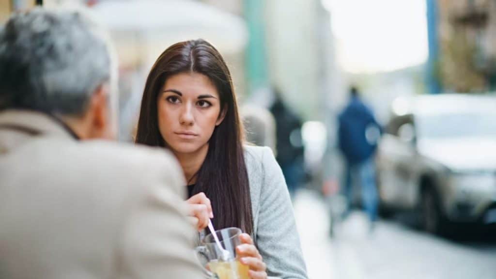 A woman with a blank expression during a conversation