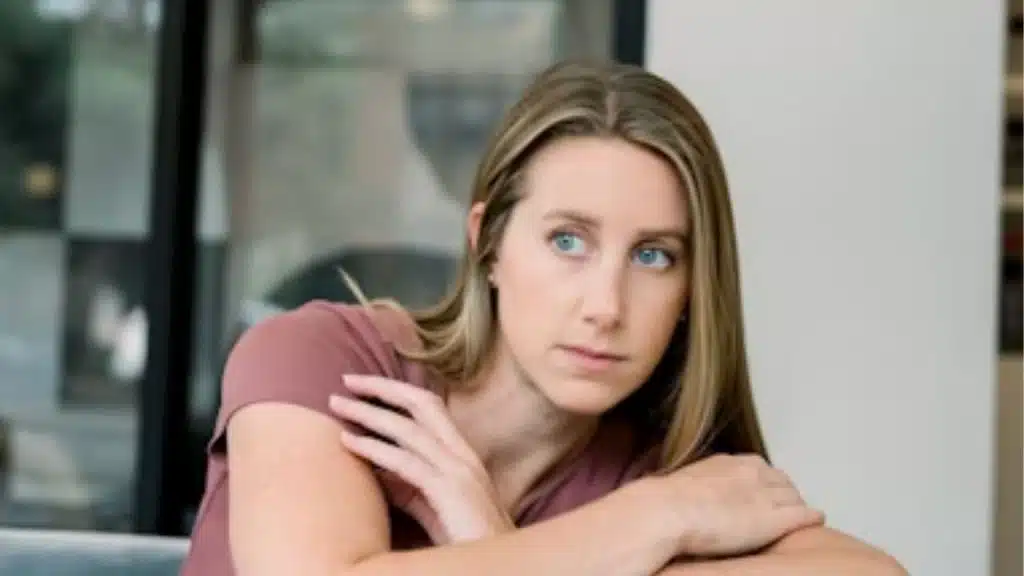 A wife with arms crossed looking away during conversation