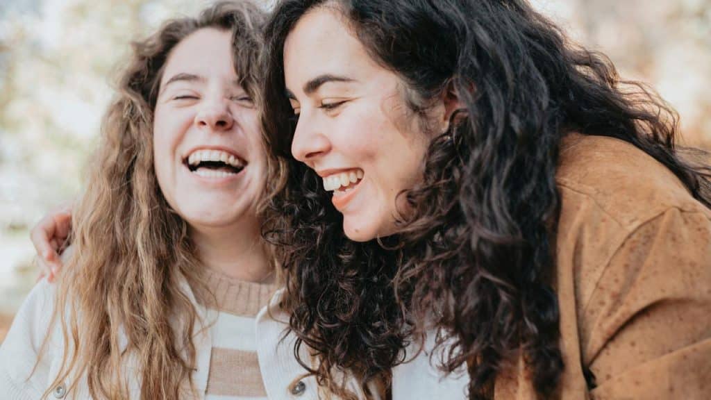 A pair of friends laugh together while enjoying each other’s company.