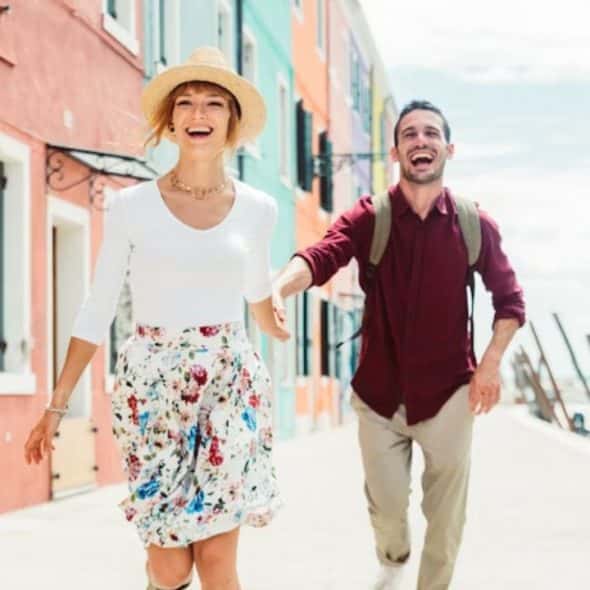 A couple holding hands while walking down.