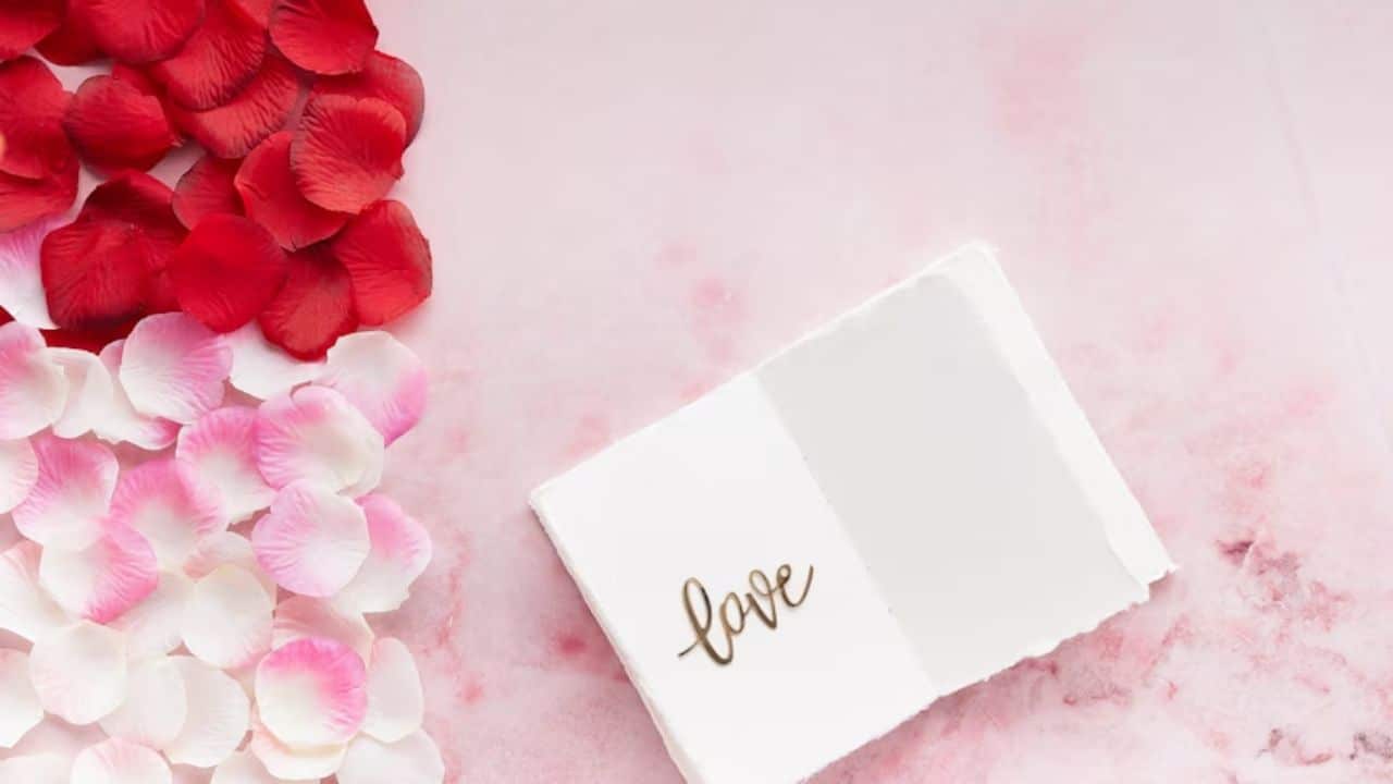 A handwritten note and flowers on a nightstand.