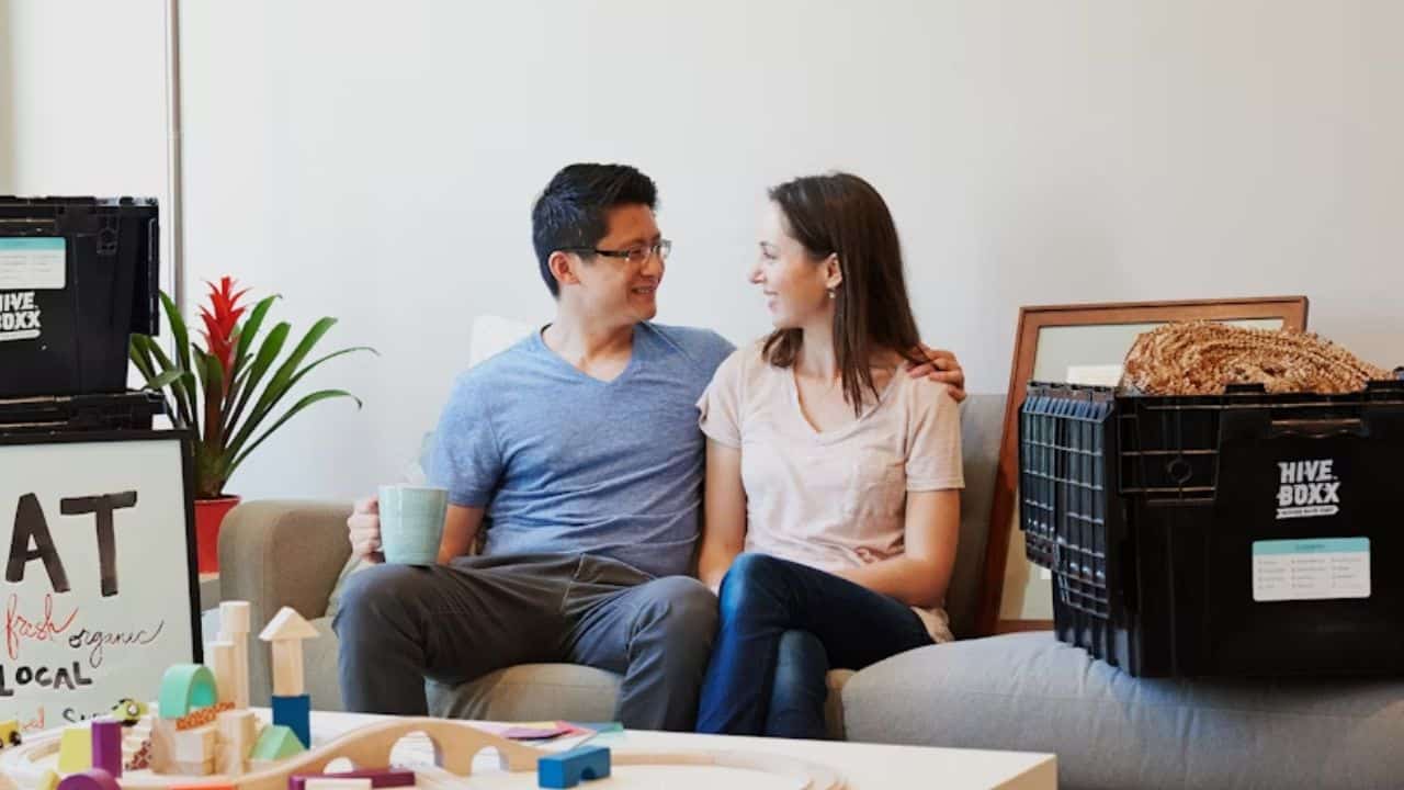 A couple having a deep conversation on a sofa.
