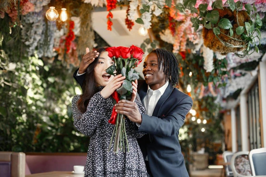 A man giving a flower to woman