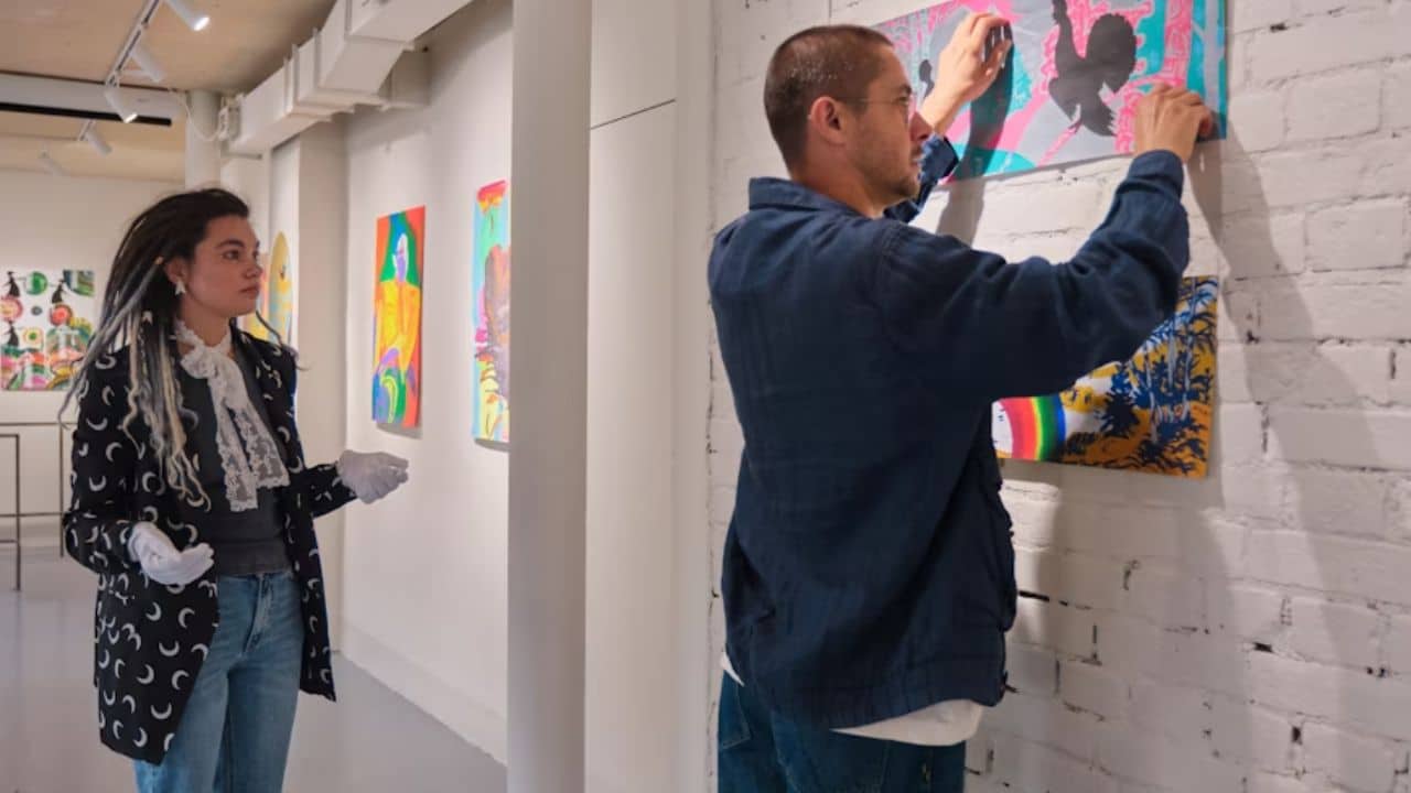 A man attending his partner’s art show.