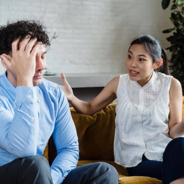 A man being silent and a woman talking to him