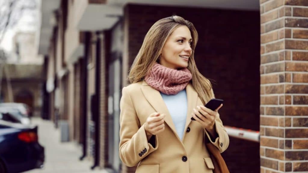 A confident woman walking alone through a city street, looking empowered