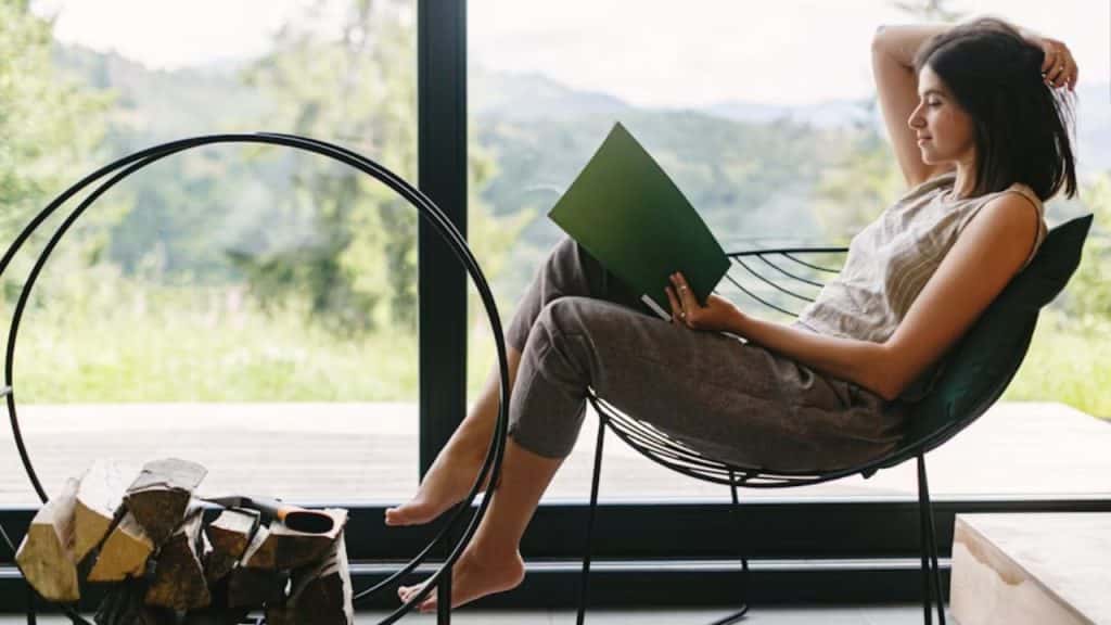 Woman journaling and reflecting in a cozy setting