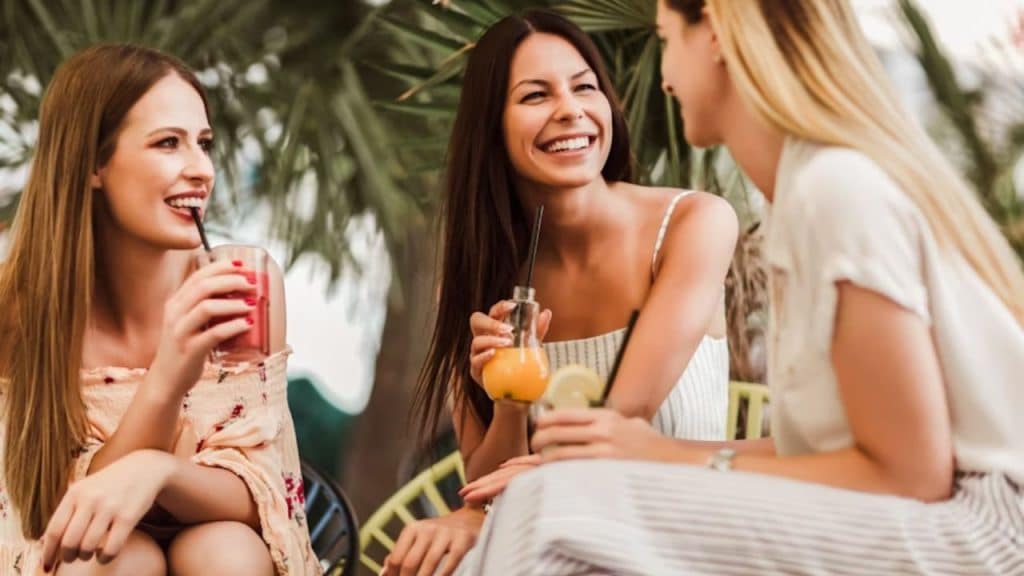 Group of women laughing and enjoying brunch together