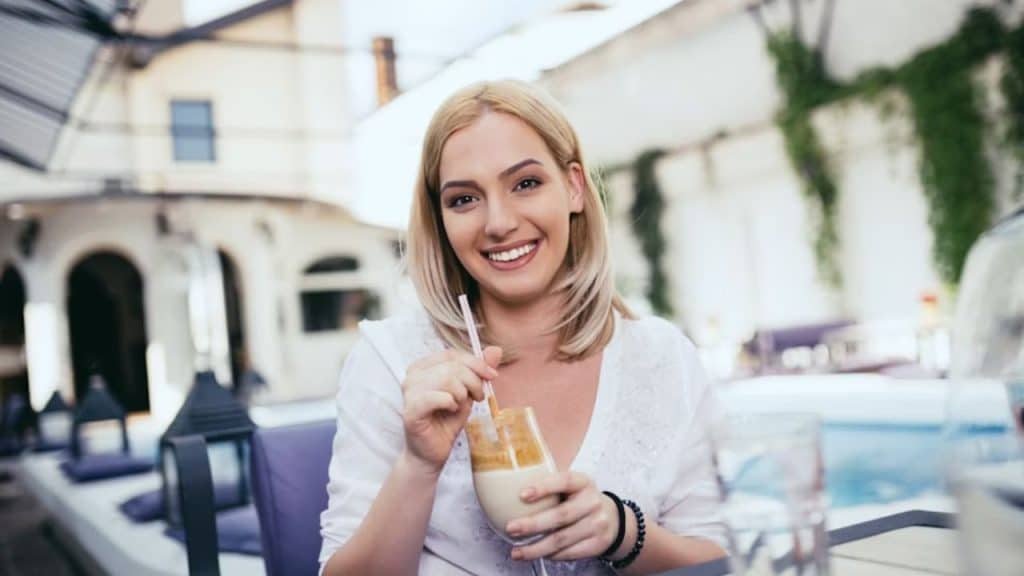 Woman smiling during a casual coffee date, relaxed and selective