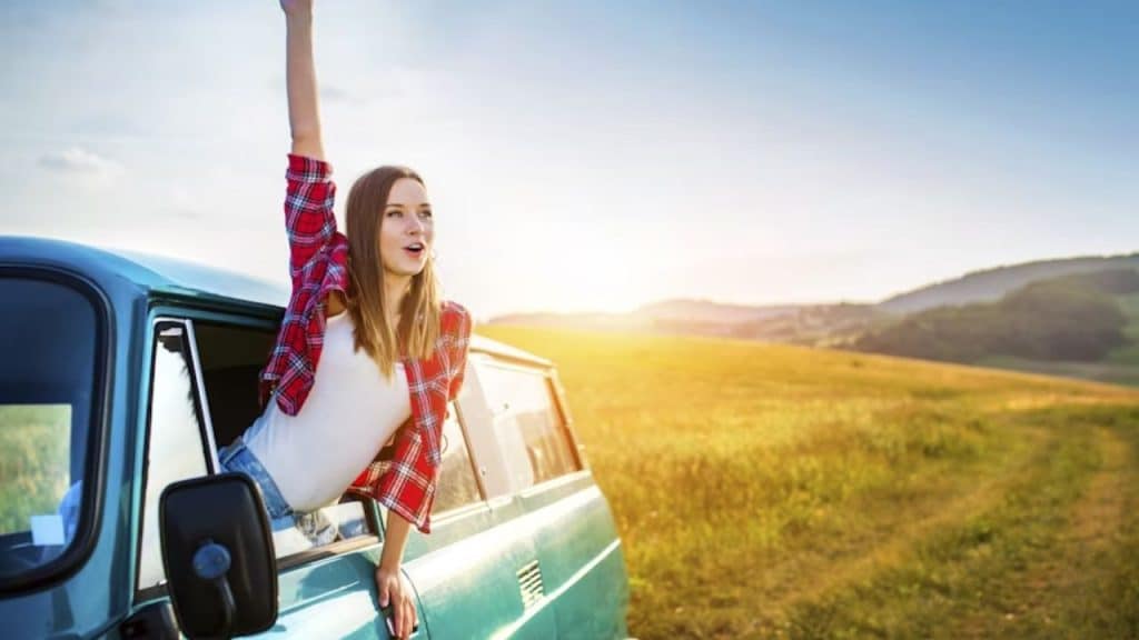 Woman smiling freely outdoors under clear blue skies